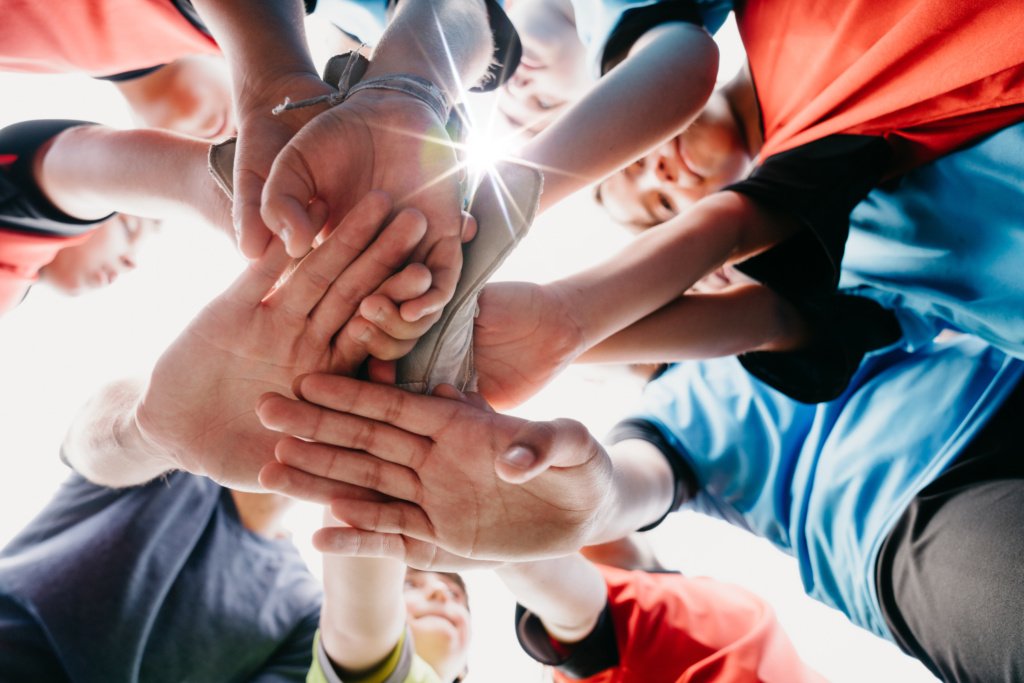 Low angle view of kids Football School Team huddling together