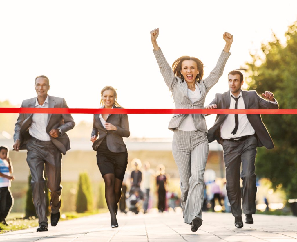 Business people running to finish, crossing red line.